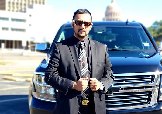 Professional security chauffeur in front of luxury SUV